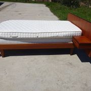 Vintage bed in teak with integrated bedside table.