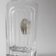 Vintage glass decanter from the 1980s, transparent glass with a silver plate and spherical stopper.