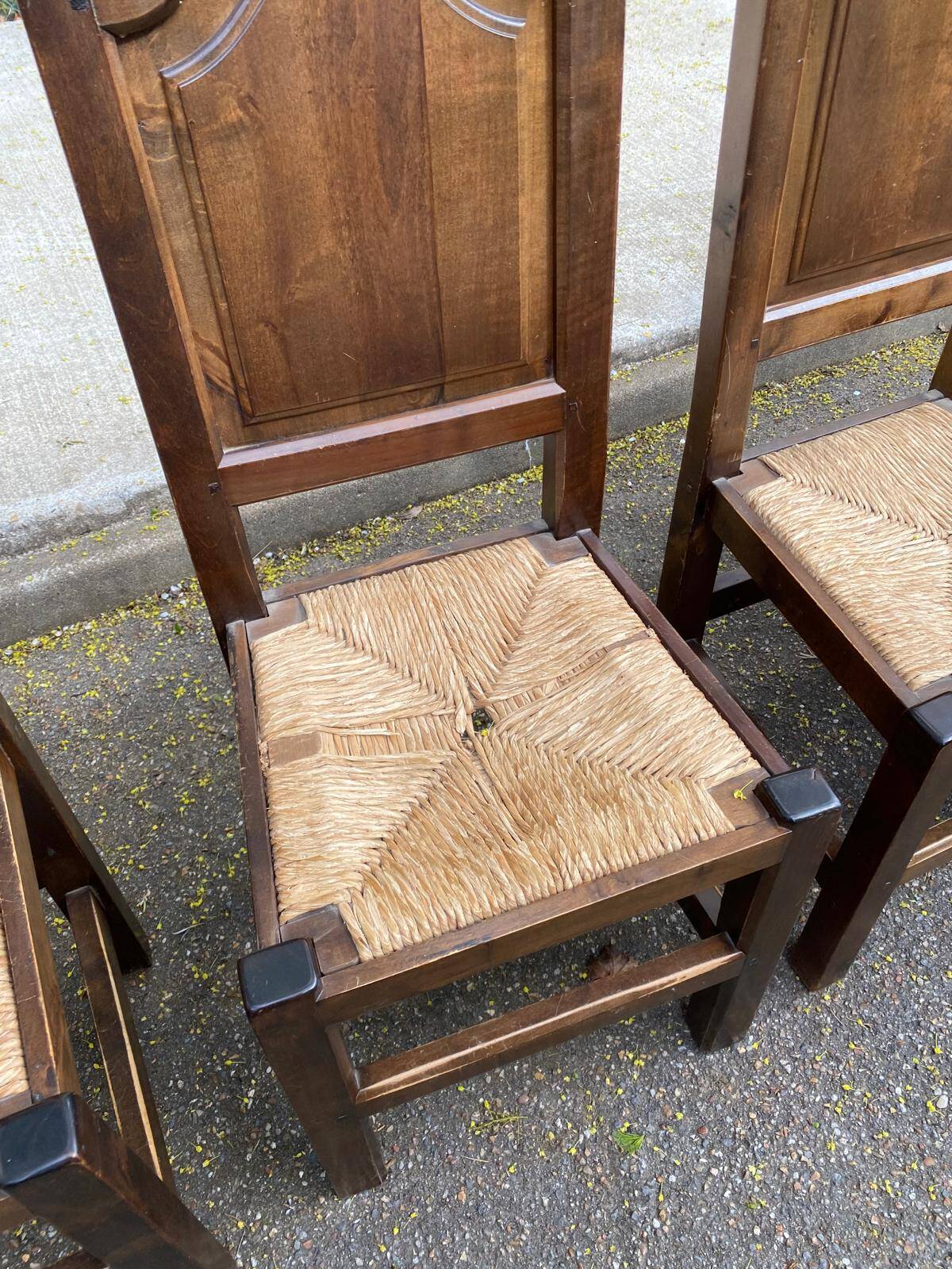 6 dining chairs in a country or farmhouse style, made of dark solid wood and rush-seated.
