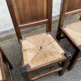 6 dining chairs in a country or farmhouse style, made of dark solid wood and rush-seated.