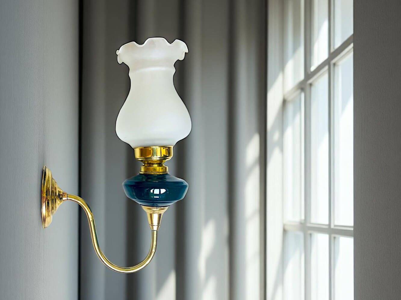 Brass wall sconce with frosted glass tulip lampshade