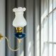 Brass wall sconce with frosted glass tulip lampshade