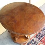 Art Deco side table in brown walnut, round top and scroll legs, France 1930s.