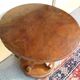 Art Deco side table in brown walnut, round top and scroll legs, France 1930s.