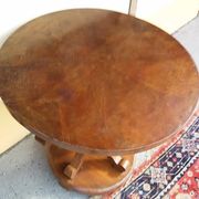 Art Deco side table in brown walnut, round top and scroll legs, France 1930s.