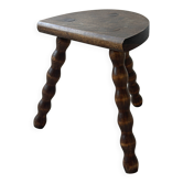 Antique solid wood stool with turned legs.