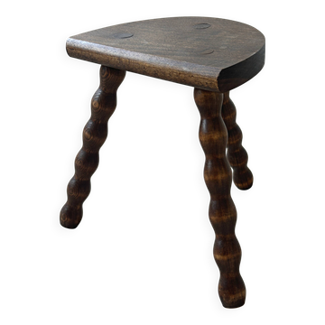 Antique solid wood stool with turned legs.