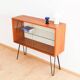 Teak display cabinet with black hairpin legs.