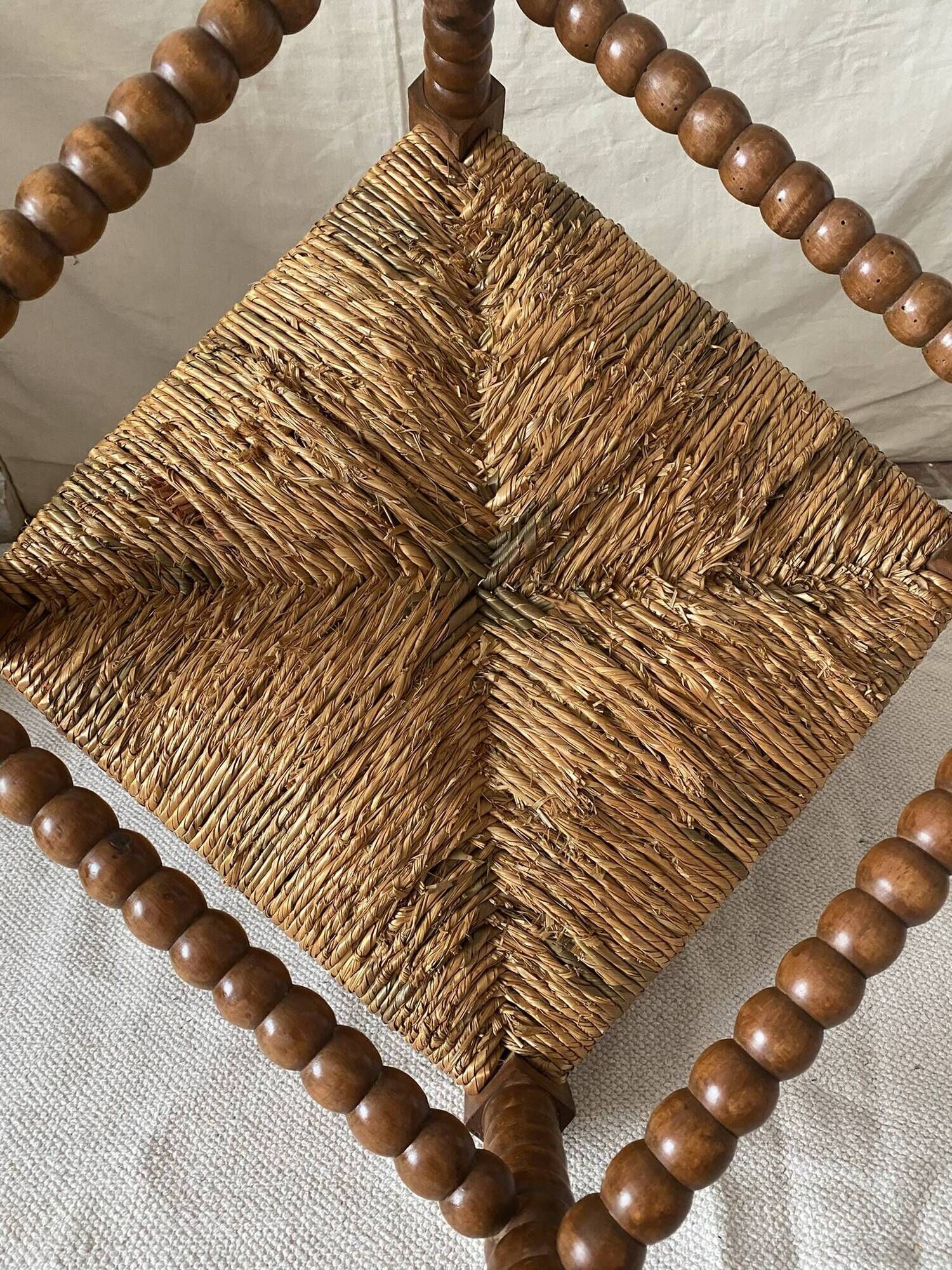 Corner chair in straw and turned wood, fireside chair.
