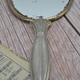 Antique hand mirror with stitched glass