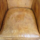 Comfortable, cozy, warm colored sheepskin club chair finished with decorative nails