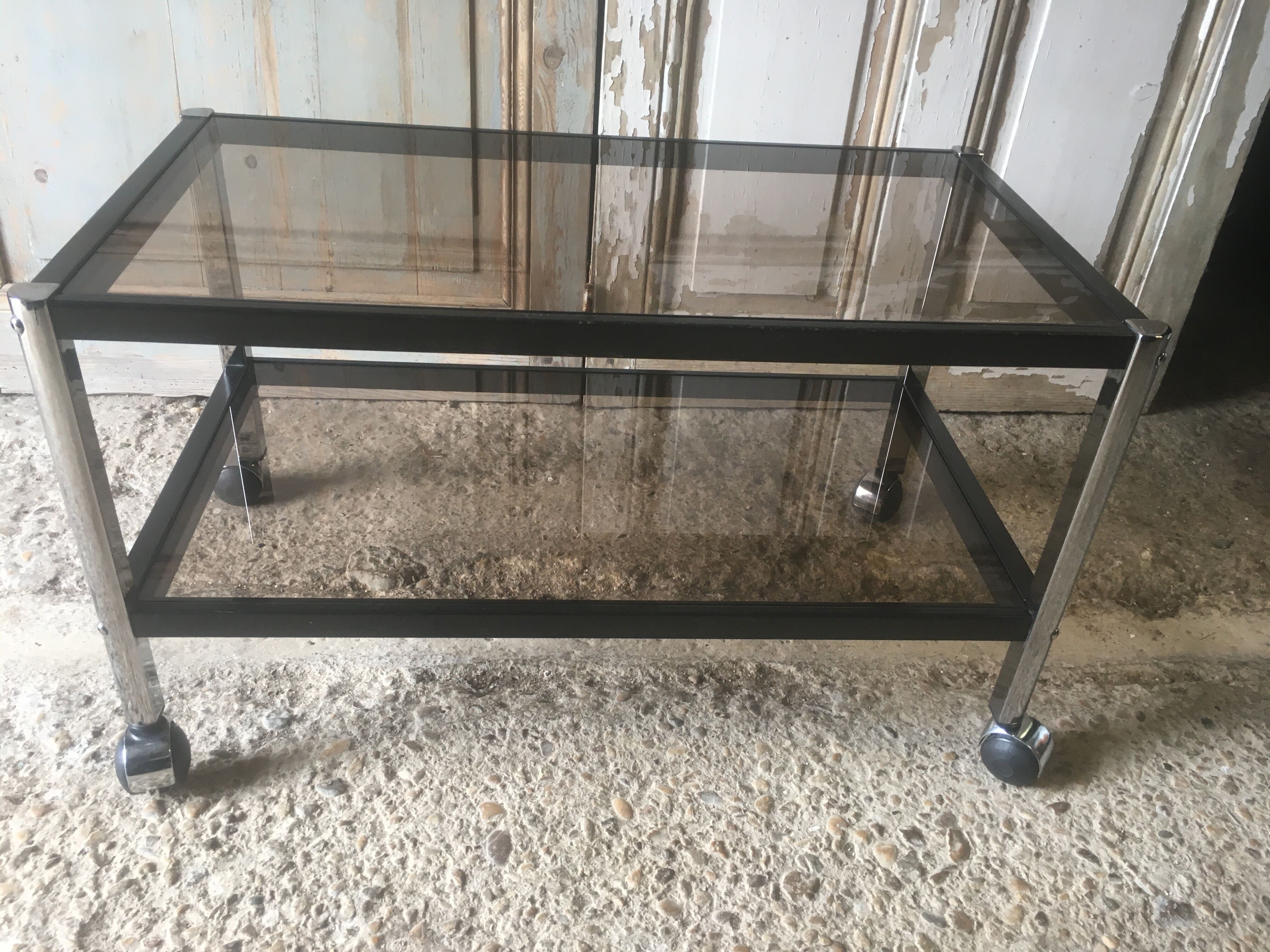 Metal coffee table with smoked glass.