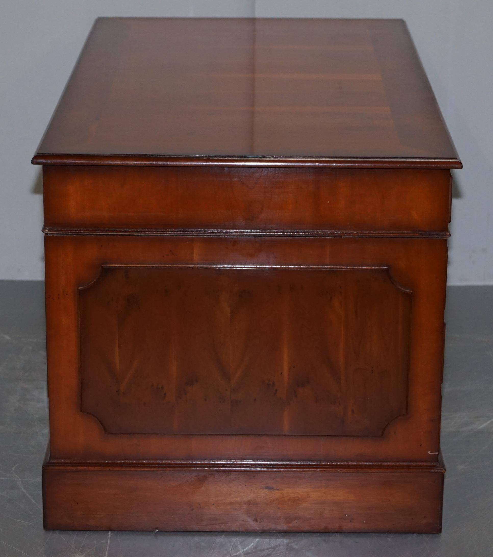 Partner desk with double pedestal in burr yew wood with decorated top.