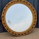 Round neoclassical style mirror in wood and gilded stucco from the 1950s