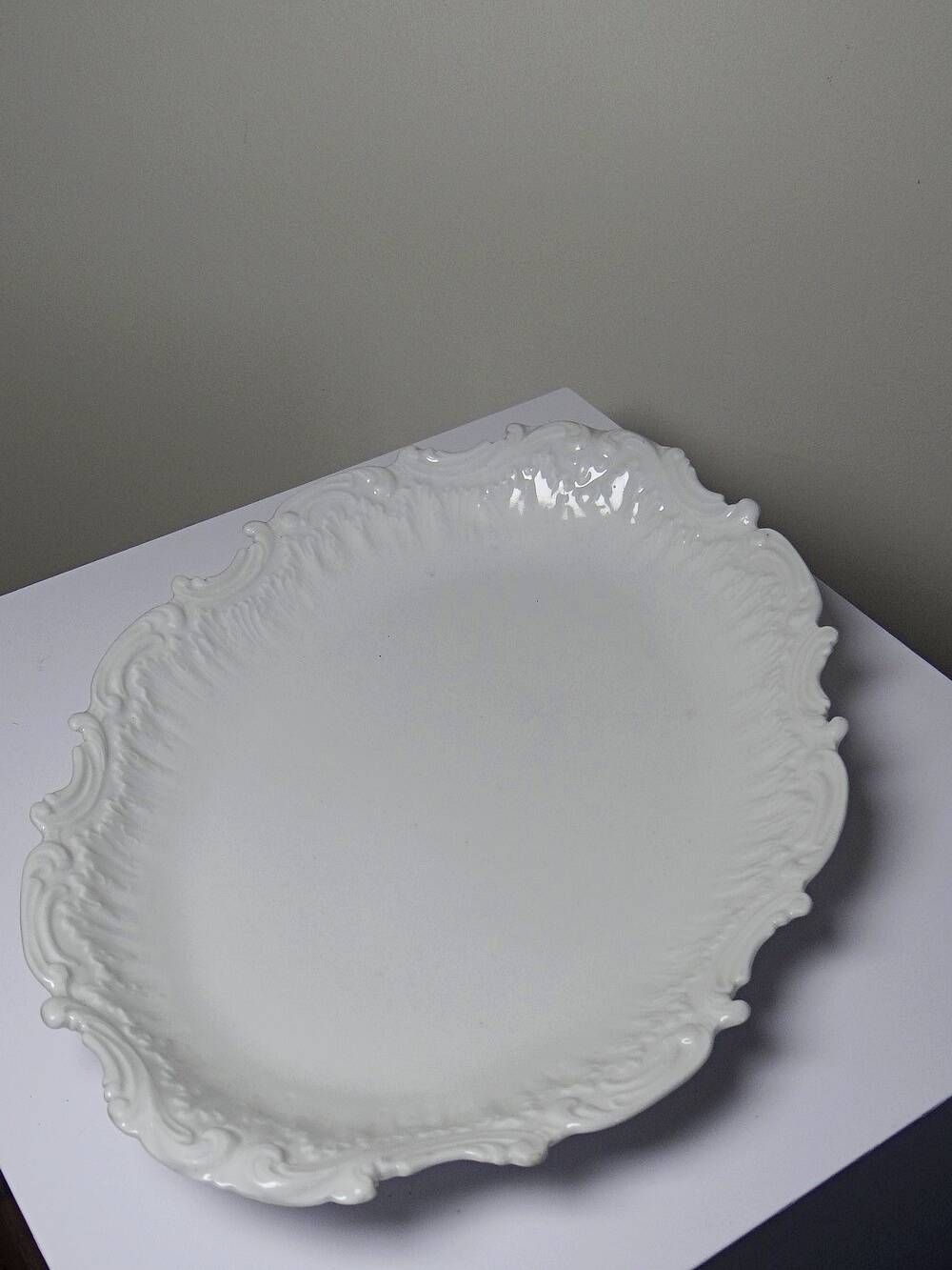 Antique deep dish in white Limoges porcelain, with rockwork relief.