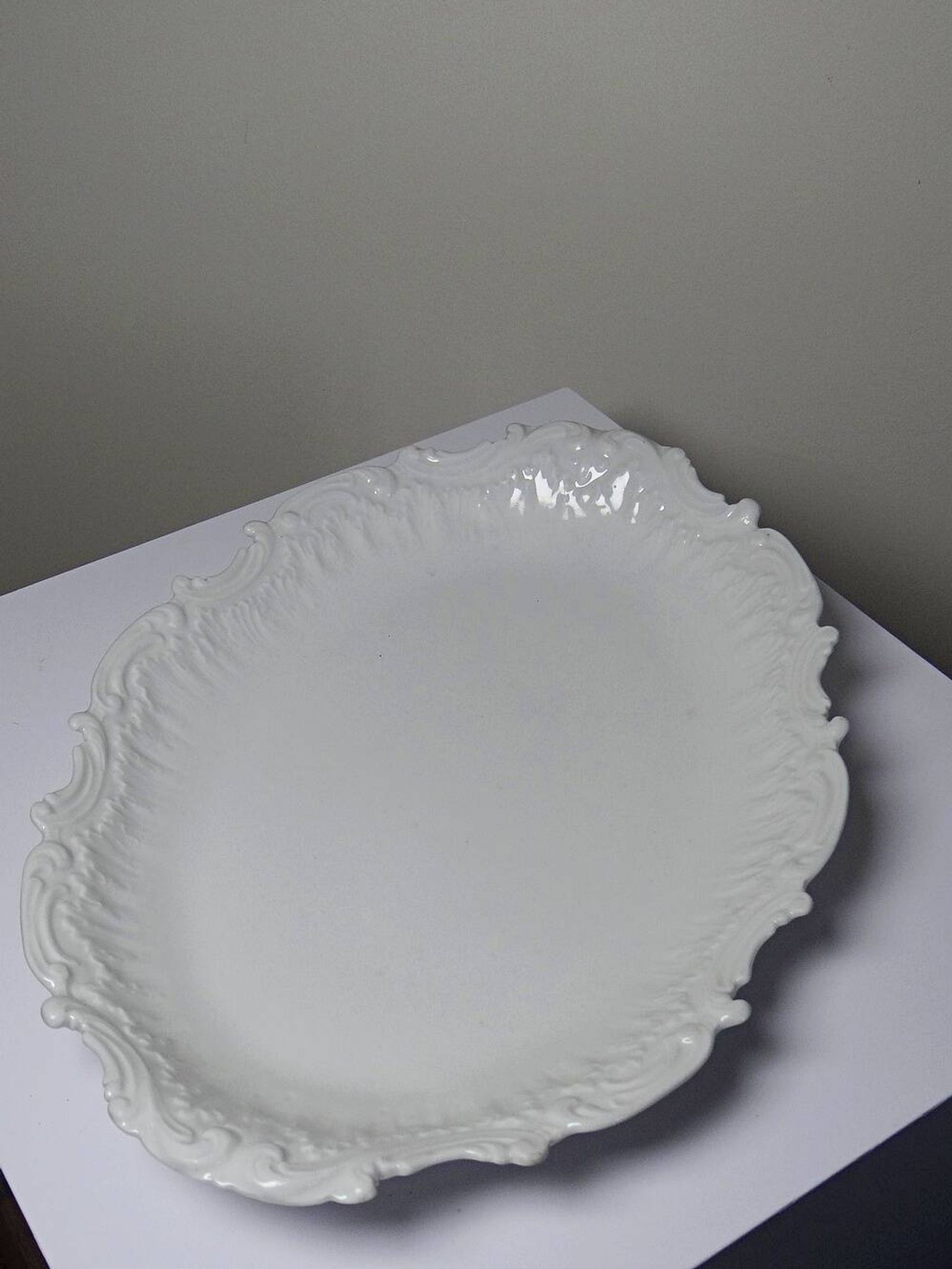 Antique deep dish in white Limoges porcelain, with rockwork relief.