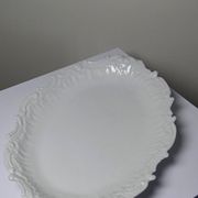 Antique deep dish in white Limoges porcelain, with rockwork relief.