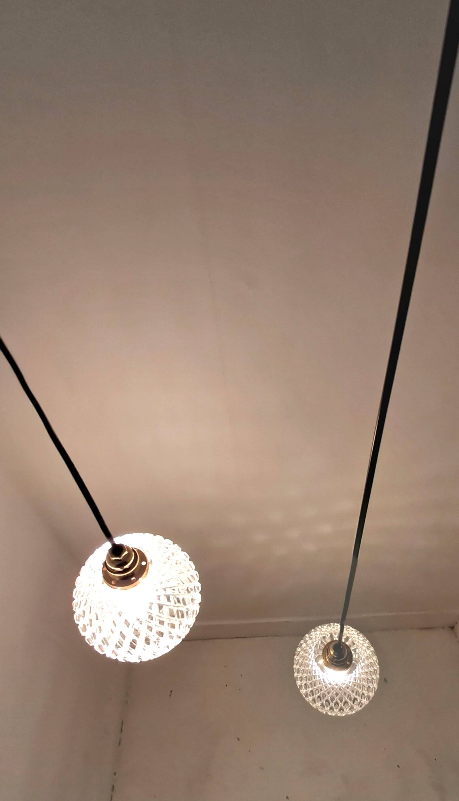 Two-light pendant in a cascade of cut crystal globe