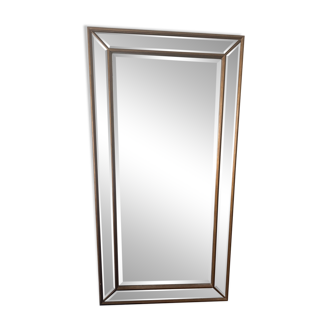 Large antique standing mirror with a wooden frame.