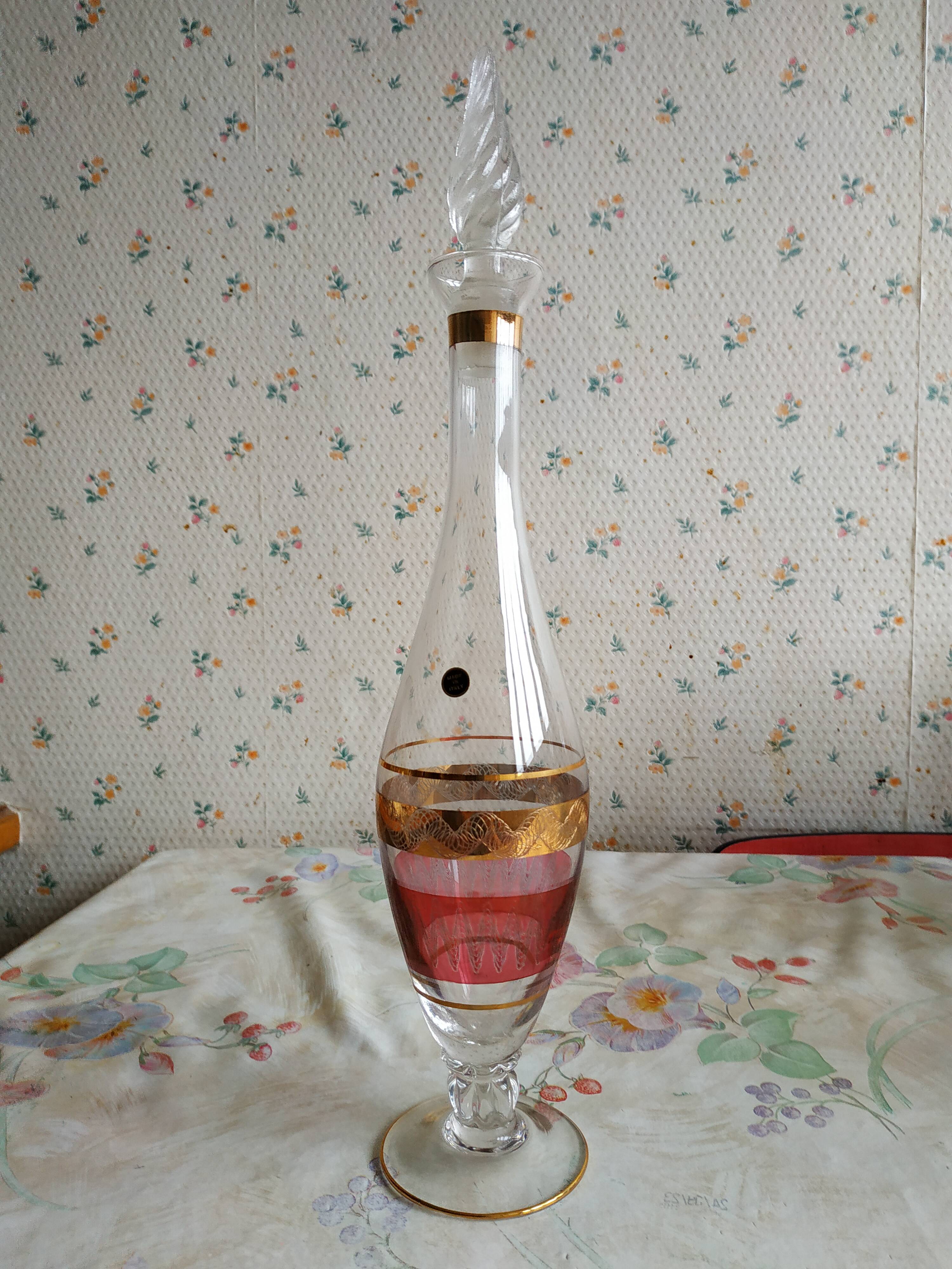 Liqueur set, colored and golden glasses and carafe