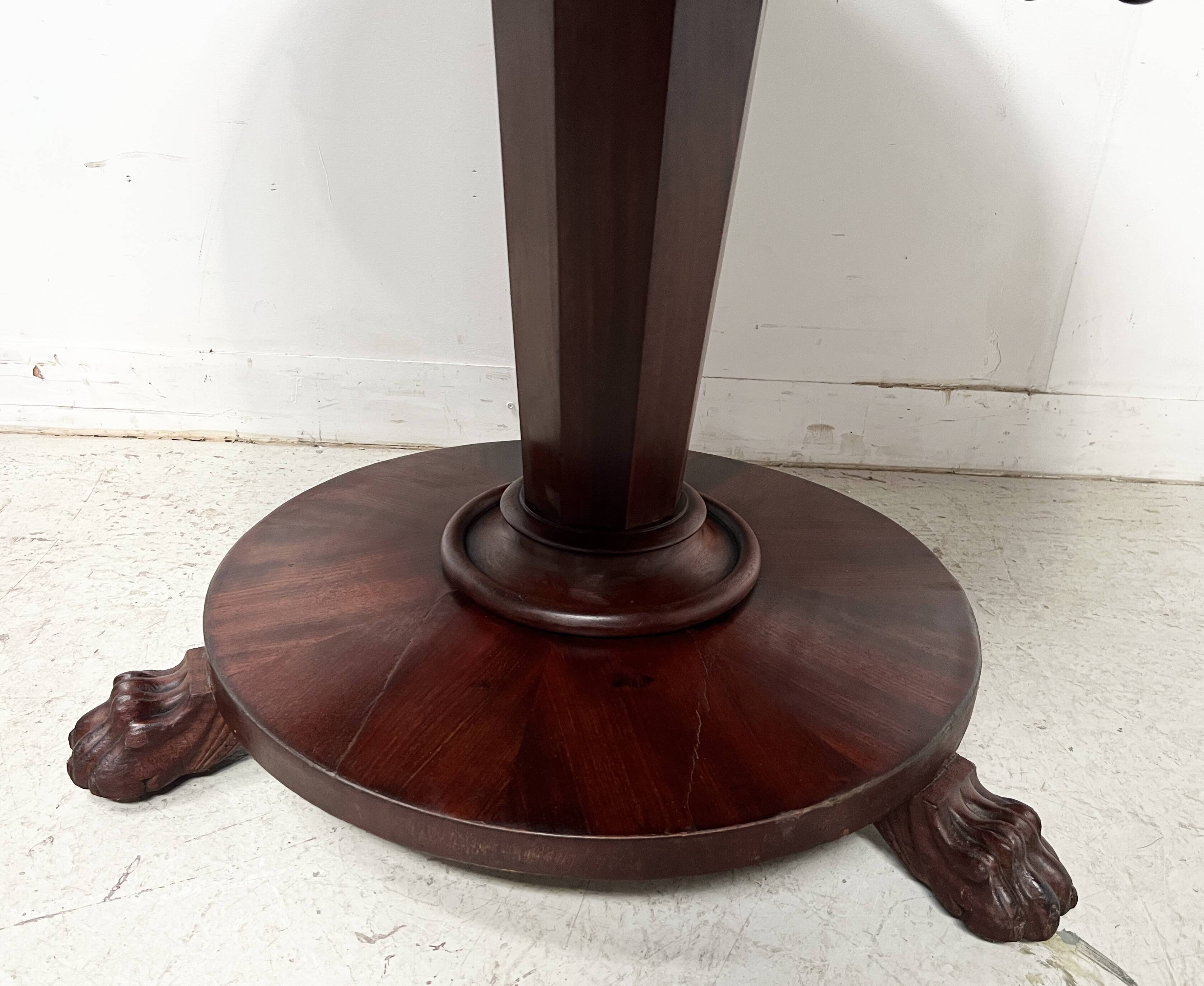 Empire style round table with claw feet, 19th century.