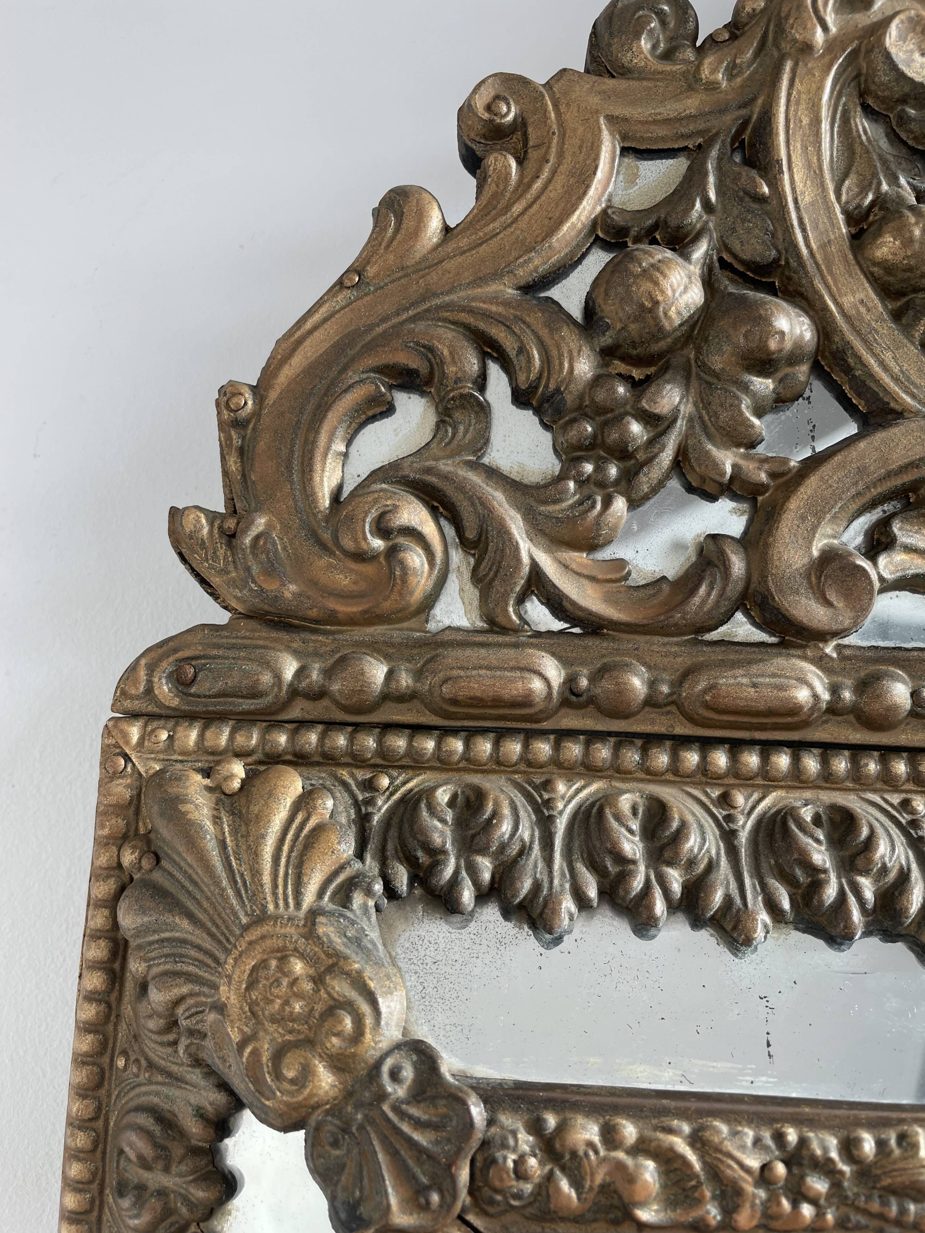 Small mirror with brass parcloses in repoussé style Louis XIV, late 19th century.