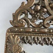 Small mirror with brass parcloses in repoussé style Louis XIV, late 19th century.