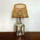 Lampe en verre et rotin