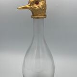 Glass bottle type carafe with gold metal bird head stopper