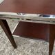 Pair of modernist chrome, leather and wood side tables.