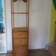 Storage column, wooden bookshelf and woven rattan.