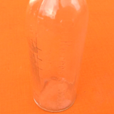 Embossed graduated apothecary bottle 1950's