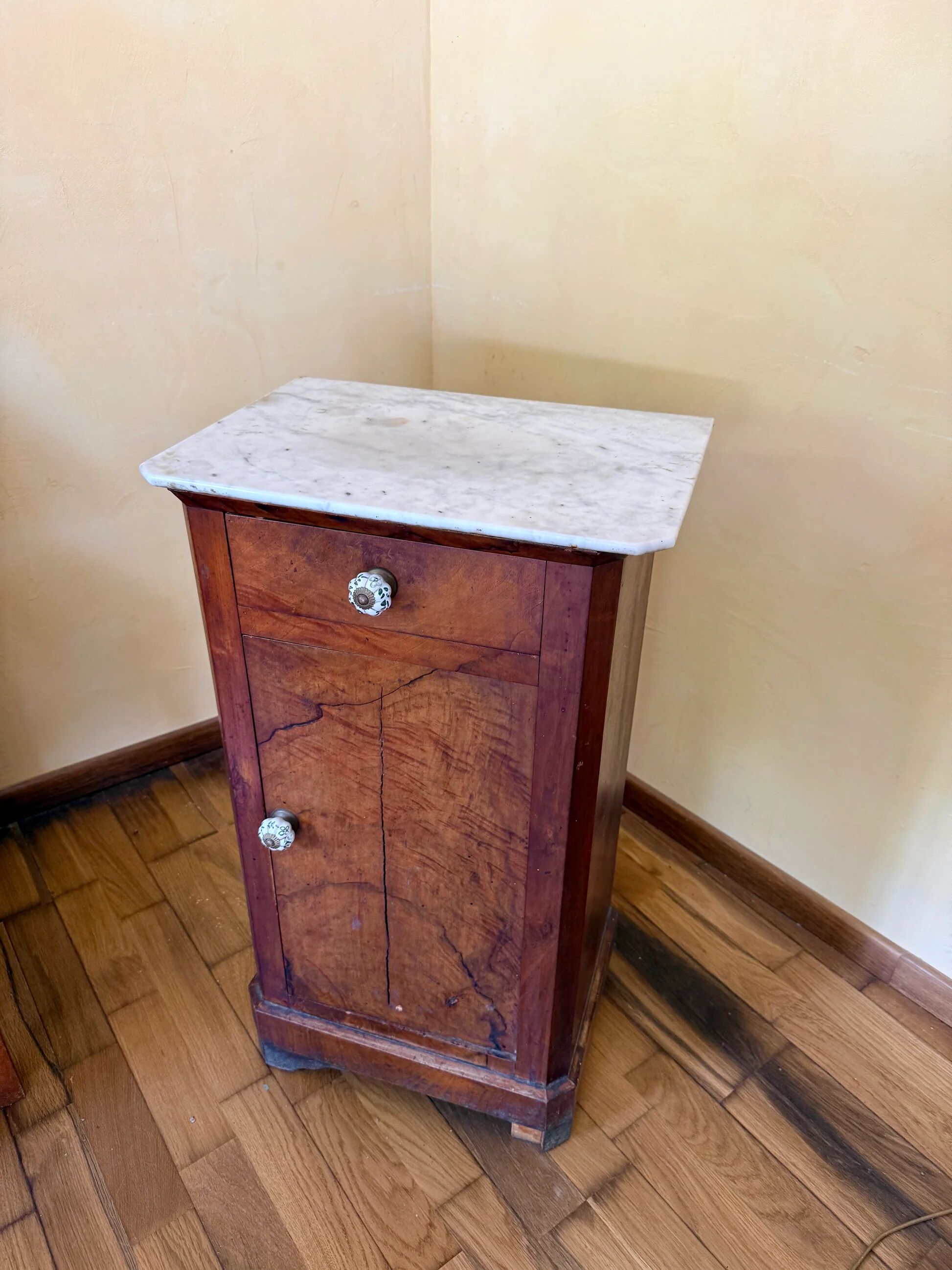 Wood and marble side table with ceramic handles.