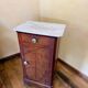 Wood and marble side table with ceramic handles.