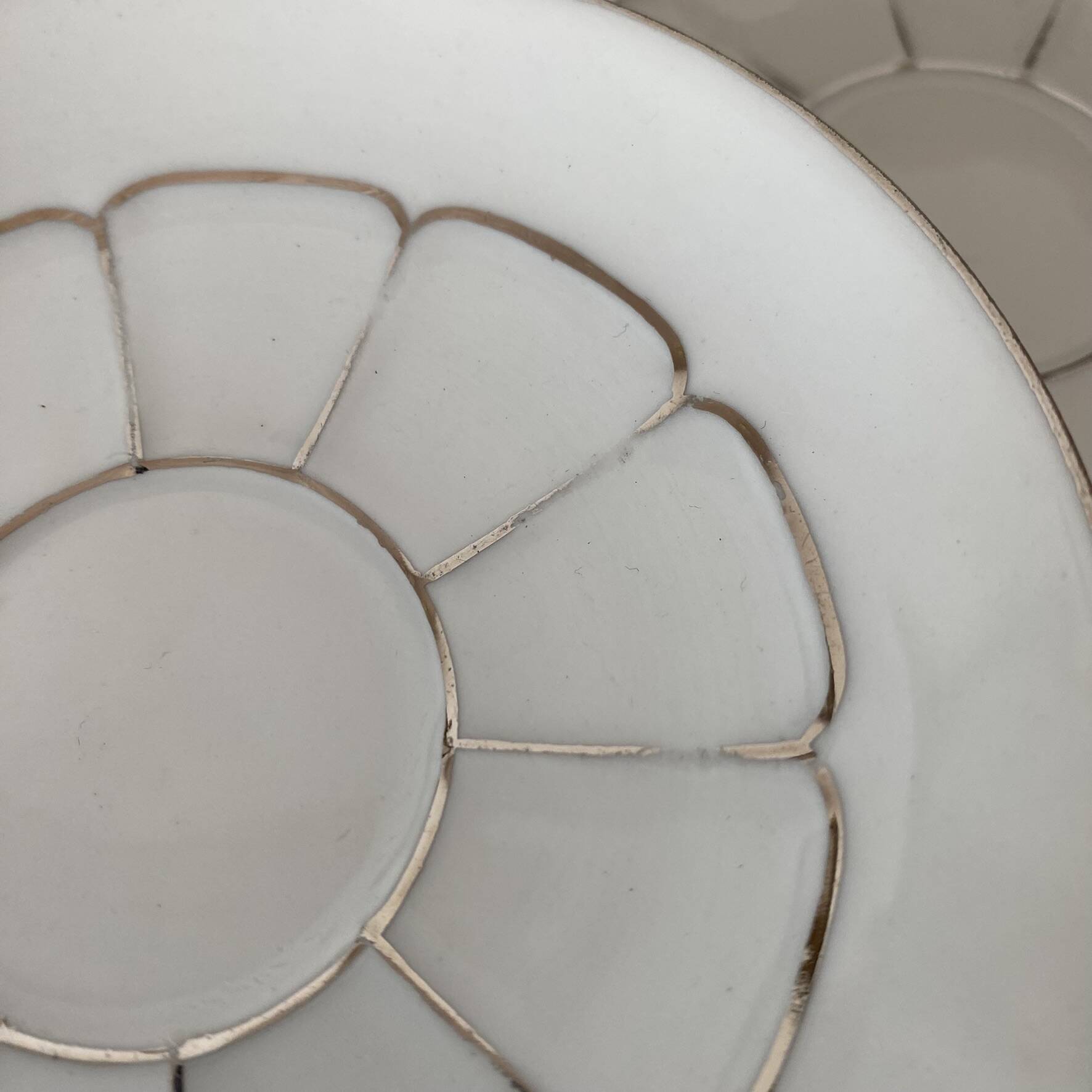 White and silver Limoges porcelain coffee cups and saucers.