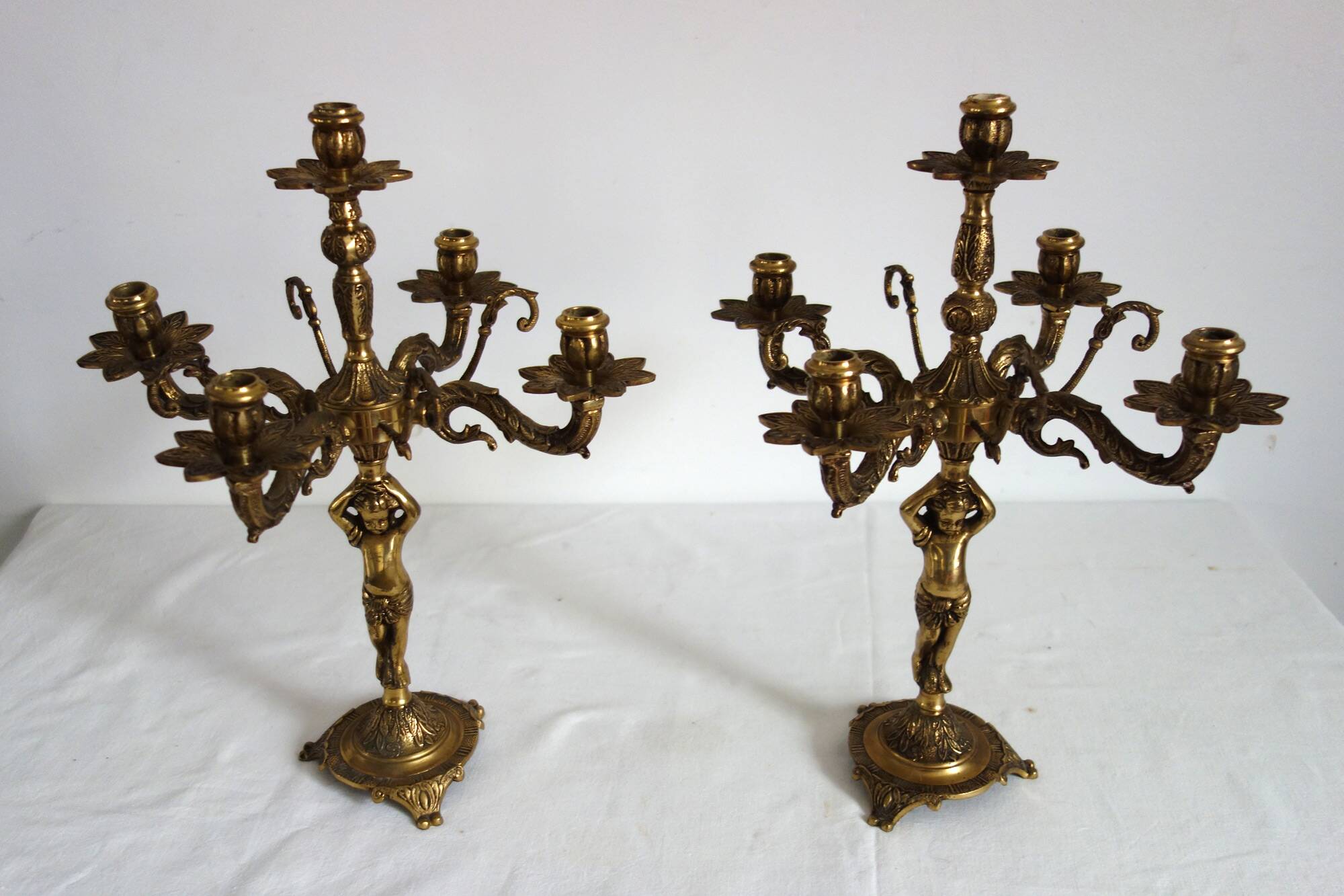 Pair of cherub candle holders in gilded bronze, early 20th century.