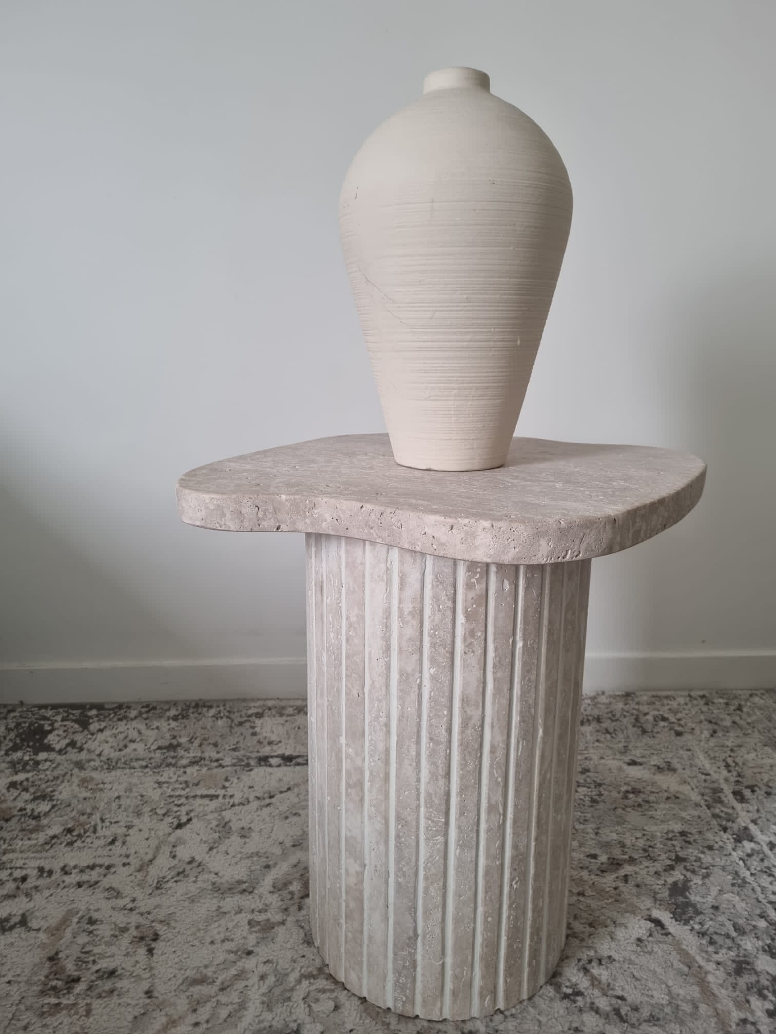 Alpha side table irregular natural travertine ribbed foot