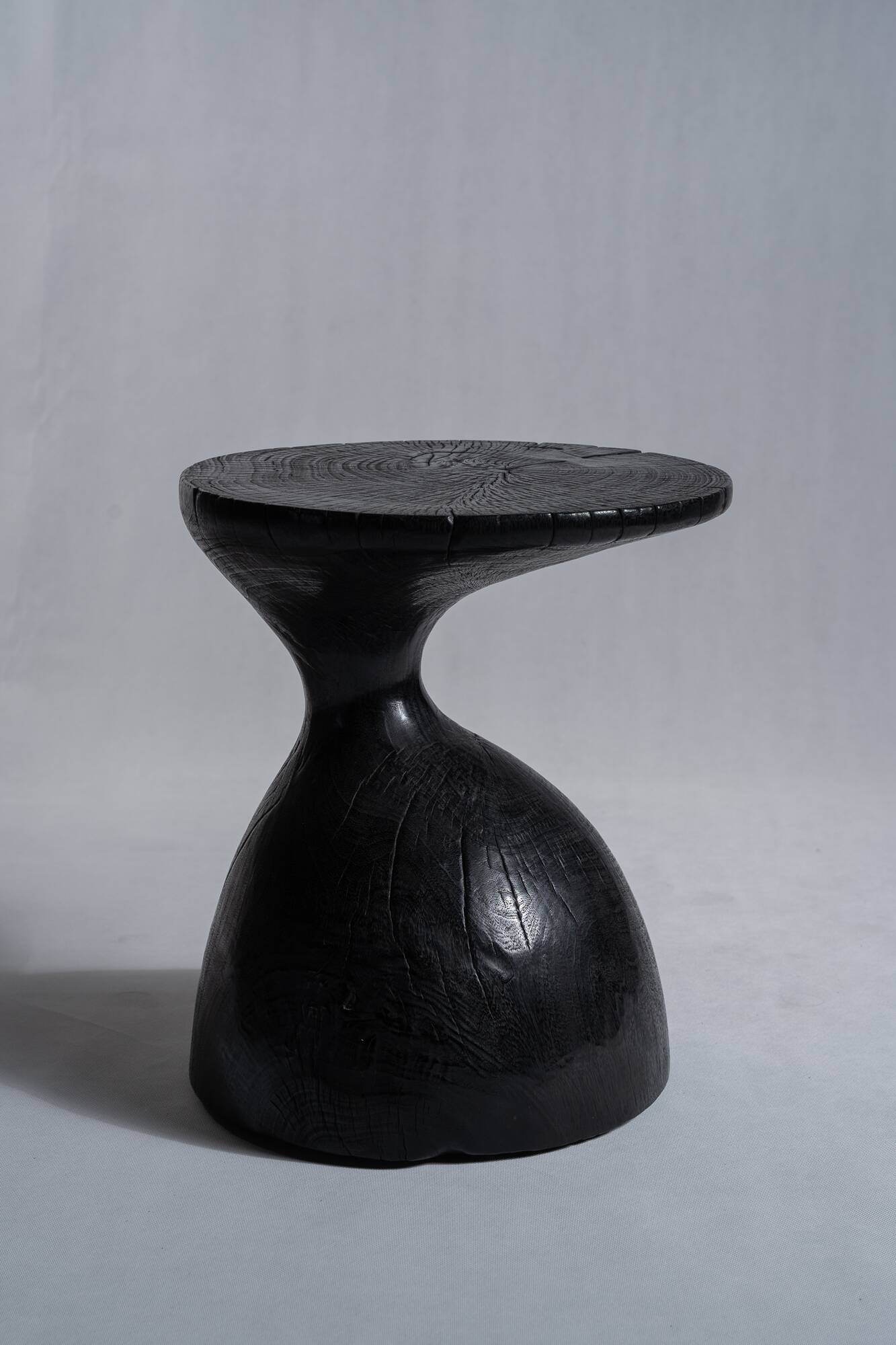 Solid wood (monoxyl) side table, organic shape, black color