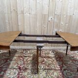 Round dining table with leather top in Louis XVI style.