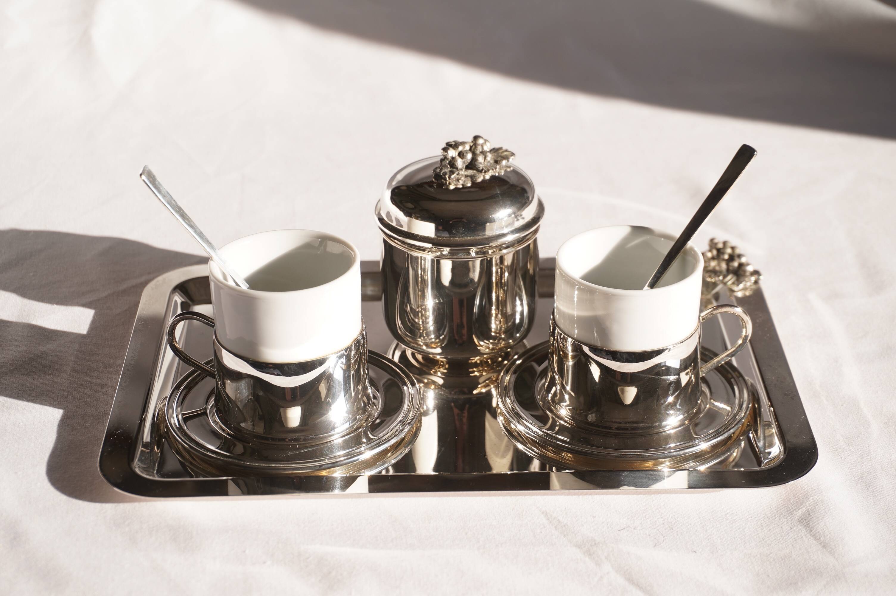 Silver-plated metal coffee service with a grape design.