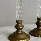 Pair of twisted metal and glass candlesticks