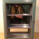 Display shelf with miniature blue wood and mirrors