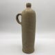 Old hot water bottle in glazed stoneware, beige color