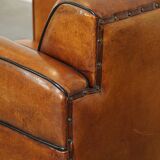 Sheepskin Art Deco design armchair with beautiful wooden details and black piping