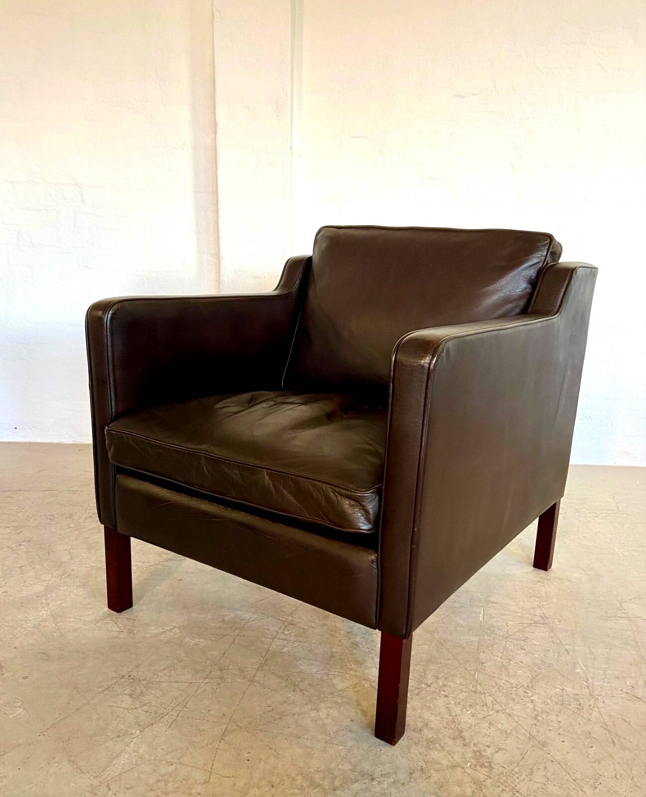 Mid-century Stouby leather lounge chair and stool in brown leather