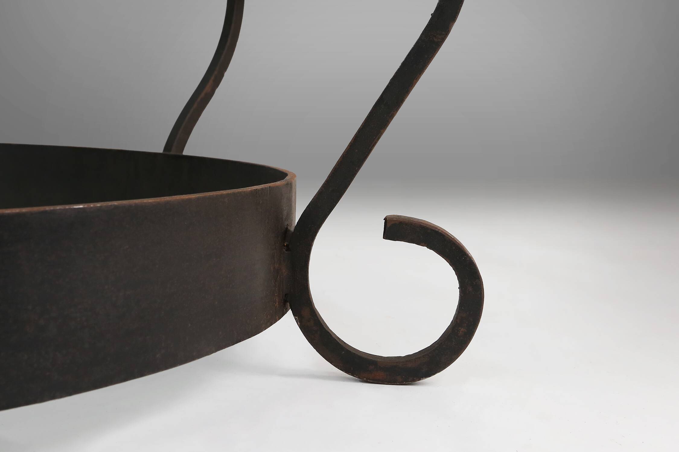 Rustic round coffee table with wrought iron base and glass top, France, 1930s