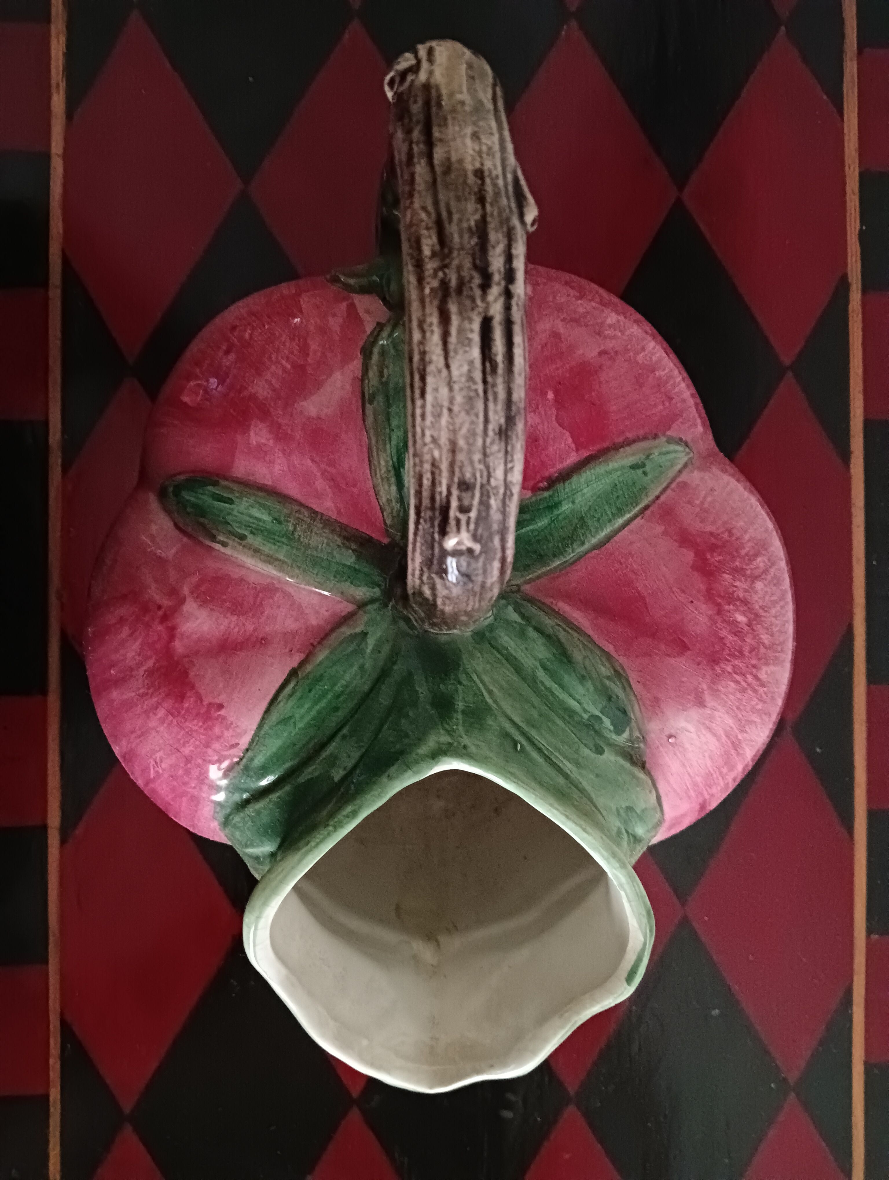 Pink pitcher in the shape of a strawberry, Italian slurry.