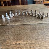 Series of 12 monogrammed silver metal knife holders