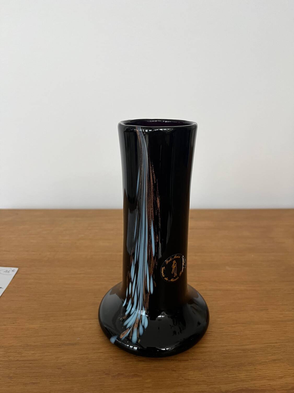 Artisanal vase in black glass with copper and blue inclusions.