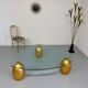 Vintage Italian design coffee table with a glass top and gold base, dating from the 1980s.